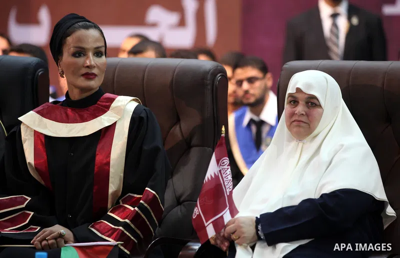 Qatar's First Lady Sheikha Mozah bint Nasser al-Missned sits with the wife of Gaza's prime minister Ismail Haniyah during a celebration at the Islamic University in Gaza city on October 23, 2012. The Emir of Qatar entere...