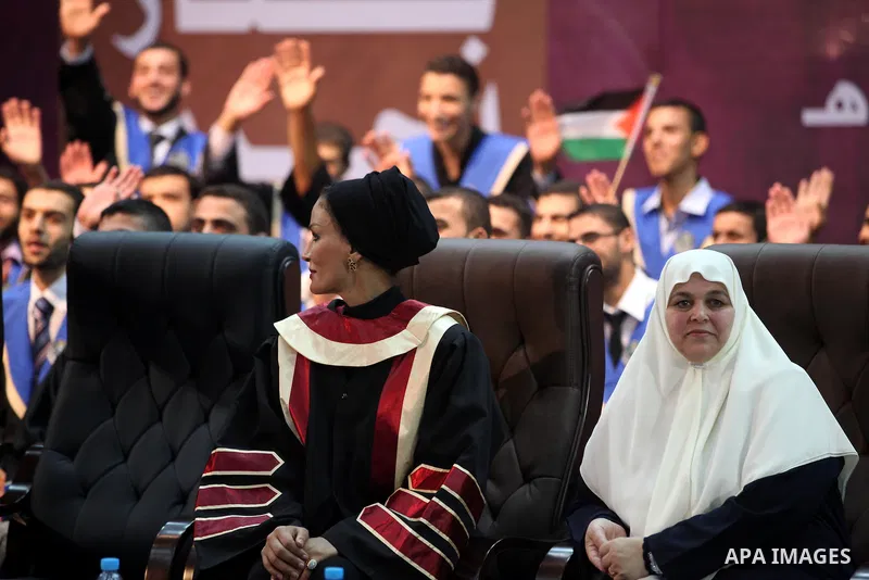 Qatar's First Lady Sheikha Mozah bint Nasser al-Missned sits with the wife of Gaza's prime minister Ismail Haniyah during a celebration at the Islamic University in Gaza city on October 23, 2012. The Emir of Qatar entere...