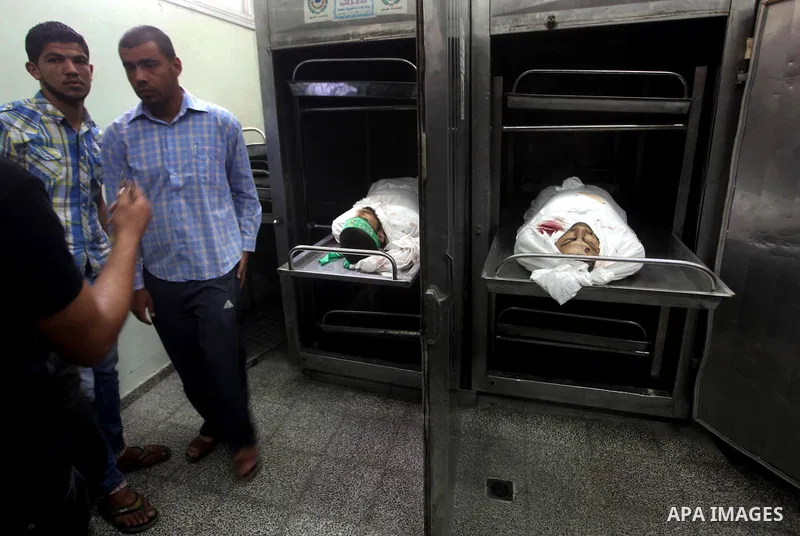 Palestinian morgue workers shows the body of Palestinian Hamas militant Louai Abu Jarad is seen at the morgue of a hospital in Beit Lahia, northern Gaza Strip, on October 24, 2012. Palestinians fired more than 40 rockets...