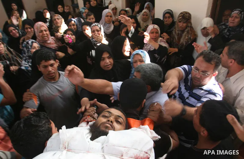 Palestinian mourners carry the body of militant Mohamed al-Shikh during his funeral in Rafah, southern Gaza Strip, on October 24, 2012. Palestinians fired more than 40 rockets from the Gaza Strip into Israel injuring thr...