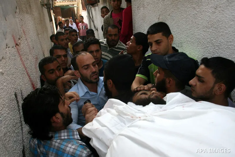 Palestinian mourners carry the body of militant Mohamed al-Shikh during his funeral in Rafah, southern Gaza Strip, on October 24, 2012. Palestinians fired more than 40 rockets from the Gaza Strip into Israel injuring thr...