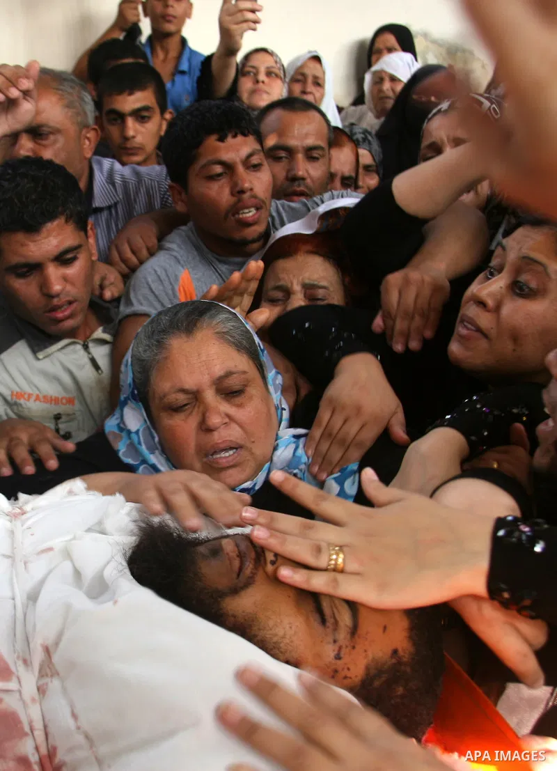 The mother of Palestinian militant Mohamed al-Shikh mourns over his body during his funeral in Rafah, southern Gaza Strip, on October 24, 2012. Palestinians fired more than 40 rockets from the Gaza Strip into Israel inju...