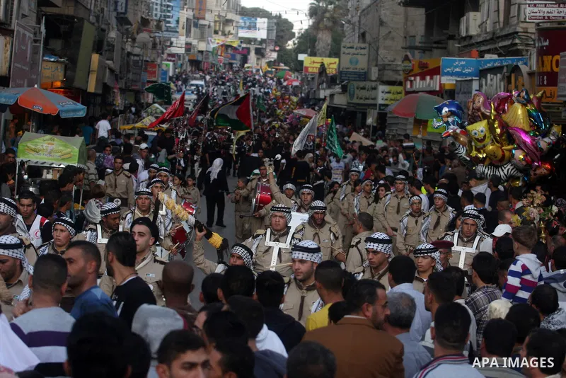 Palestinian boy scouts march through streets during a rally in celebration the Muslim festival of Eid al-Adha, in the West Bank city of Ramallah, on October 25, 2012. Muslims around the world prepare to celebrate Eid Al-...