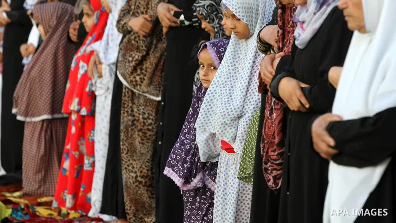 Palestinians attend Eid Al-Adha prayers on the first day of the Muslim holiday, at the Palestine Stadium in Gaza City, on October 26, 2012. Muslims around the world celebrate Eid al-Adha to mark the end of the haj by sla...