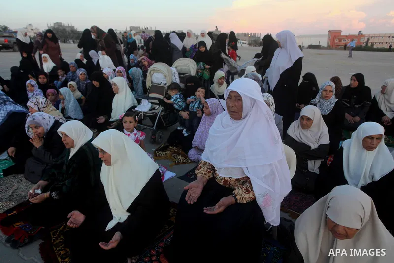 Palestinians listen to a speech by Palestinian Prime Minister in gaza, Ismail Haniya during a mass prayer on the first day of the Muslim holiday of Eid al-Adha, at al-Nusairat, in the central Gaza Strip, on October 26, 2...
