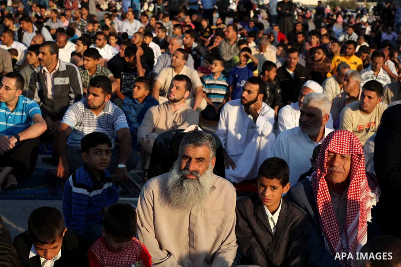 Palestinians listen to a speech by Palestinian Prime Minister in gaza, Ismail Haniya during a mass prayer on the first day of the Muslim holiday of Eid al-Adha, at al-Nusairat, in the central Gaza Strip, on October 26, 2...
