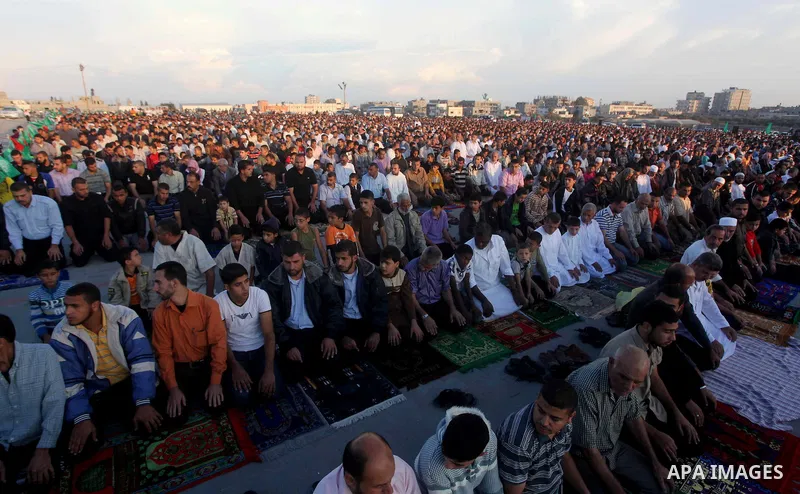 Palestinians listen to a speech by Palestinian Prime Minister in gaza, Ismail Haniya during a mass prayer on the first day of the Muslim holiday of Eid al-Adha, at al-Nusairat, in the central Gaza Strip, on October 26, 2...