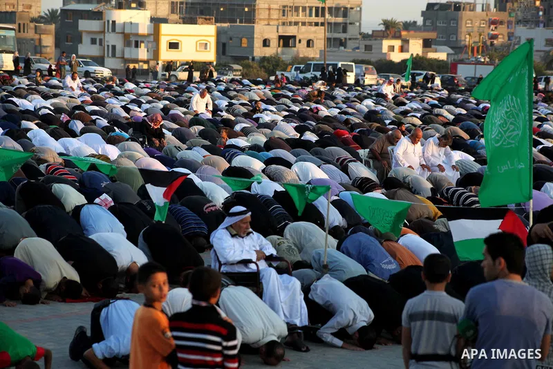 Palestinians listen to a speech by Palestinian Prime Minister in gaza, Ismail Haniya during a mass prayer on the first day of the Muslim holiday of Eid al-Adha, at al-Nusairat, in the central Gaza Strip, on October 26, 2...