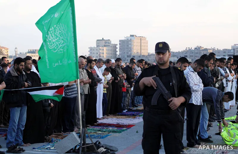 Hamas security forces stand guard during a mass prayer on the first day of the Muslim holiday of Eid al-Adha, at al-Nusairat, in the central Gaza Strip, on October 26, 2012. Muslims around the world celebrate Eid al-Adha...