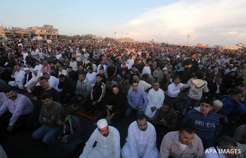 Palestinians listen to a speech by Palestinian Prime Minister in gaza, Ismail Haniya during a mass prayer on the first day of the Muslim holiday of Eid al-Adha, at al-Nusairat, in the central Gaza Strip, on October 26, 2...