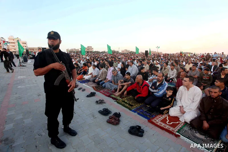 Hamas security forces stand guard during a mass prayer on the first day of the Muslim holiday of Eid al-Adha, at al-Nusairat, in the central Gaza Strip, on October 26, 2012. Muslims around the world celebrate Eid al-Adha...