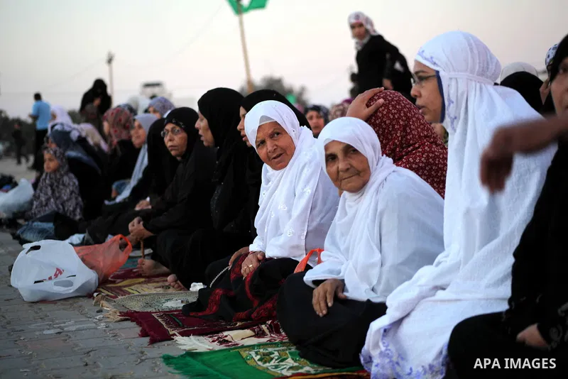 Palestinians listen to a speech by Palestinian Prime Minister in gaza, Ismail Haniya during a mass prayer on the first day of the Muslim holiday of Eid al-Adha, at al-Nusairat, in the central Gaza Strip, on October 26, 2...