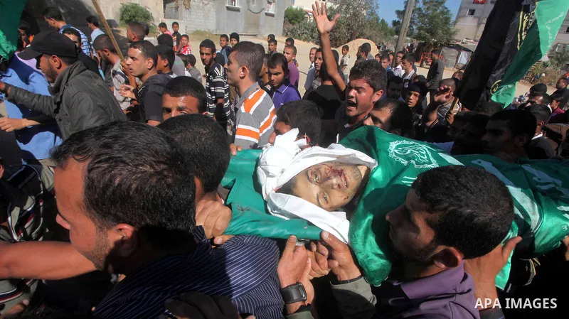 Palestinians carry the body of Suleiman al-Qarra during his funeral in Khanions, Southern Gaza Strip, on October 28, 2012. Israel killed the Hamas gunman it accused of preparing to fire a rocket from the Gaza Strip . Pho...