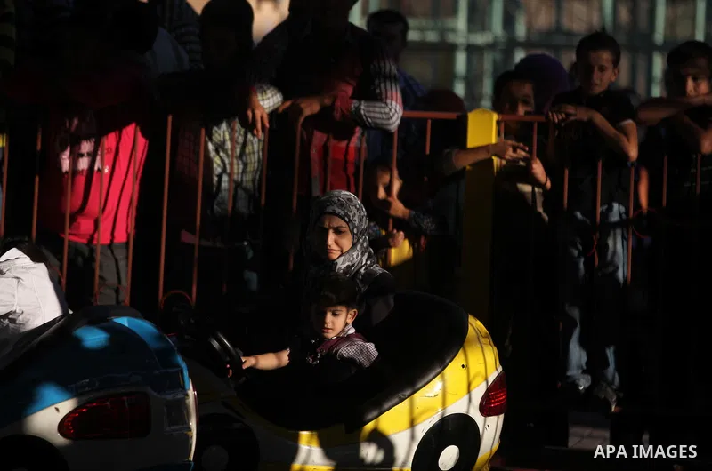 Palestinians enjoy themselves at an amusement park in Gaza City as the Muslim world celebrates the third day of the Eid al-Adha holiday on October 28, 2012. Eid al-Adha or "Feast of the Sacrifice" marks the end of the an...