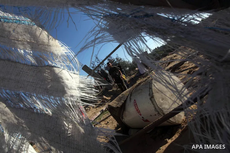 Palestinians inspect the damage to a building following an Israeli attack in al-Bureij, in the center of the Gaza Strip on October 29, 2012. Gaza militants fired 11 rockets over the border overnight in response to two la...
