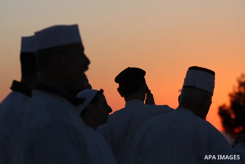 Members of the ancient Samaritan community, wrapped in a prayer shawl participate in the pilgrimage for the holy day of the Tabernacles or Sukkot at the religion's holiest site on the top of Mount Gerizim near the West B...