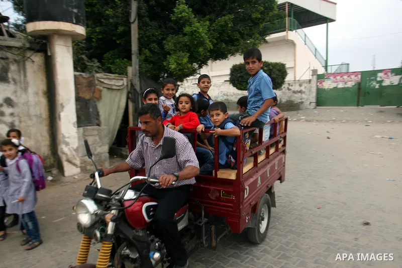 Palestinian children ride a motorcycle known as "Toktok" after a school day in Rafah refugee camp southern the Gaza strip, Oct. 31, 2012. In the aftermath of the Israeli military Operation Cast Lead in 2008/2009, Palesti...
