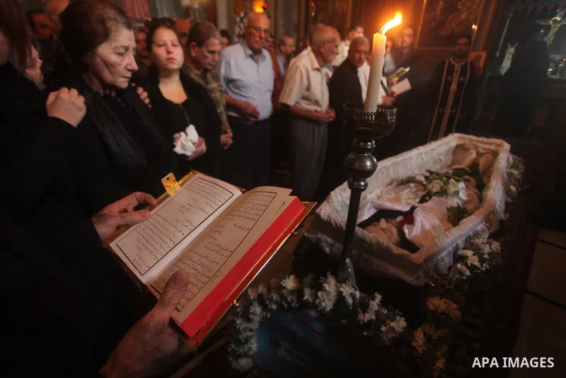 Palestinian relatives of Christian Hossam Al-Tawil mourn on his body during his funeral at the Church of Saint Porphyrius in Gaza city on Nov. 01, 2012. Al-Tawil passed away in Egypt after seeking medical treatment in th...