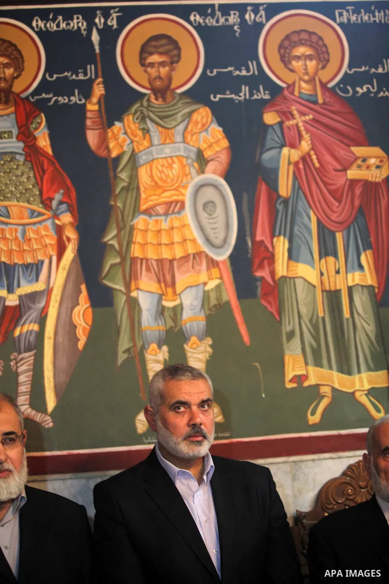 Palestinian Prime Minister in Gaza strip Ismail Haniyeh condoles the relatives of Christian Hossam Al-Tawil during his funeral at the Church of Saint Porphyrius in Gaza city on Nov. 01, 2012. Al-Tawil passed away in Egyp...