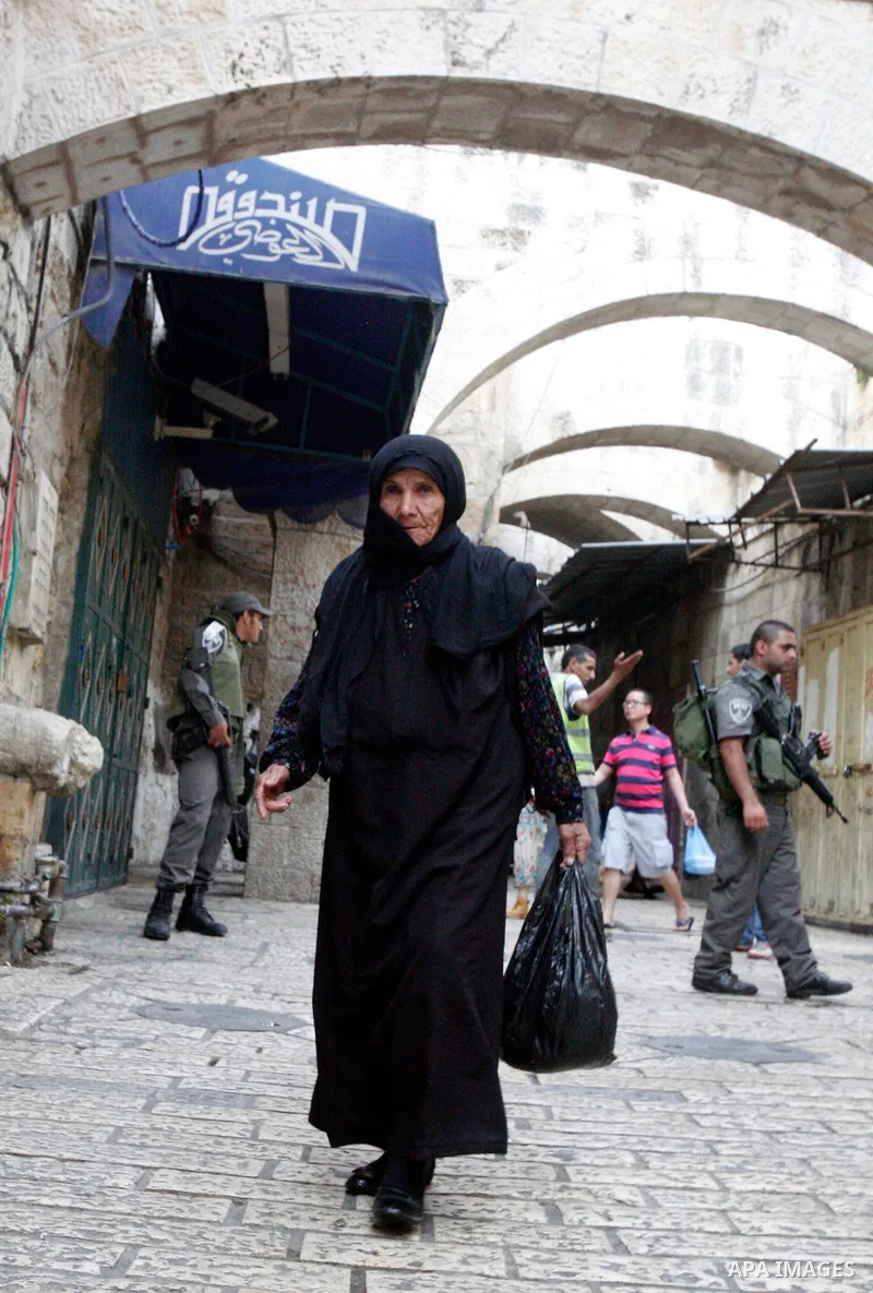 A Palestinian woman walks out at al-Aqsa Mosque compound after Friday prayer in Jerusalem's old city on 02 November 2012. Photo by Mahfouz Abu Turk