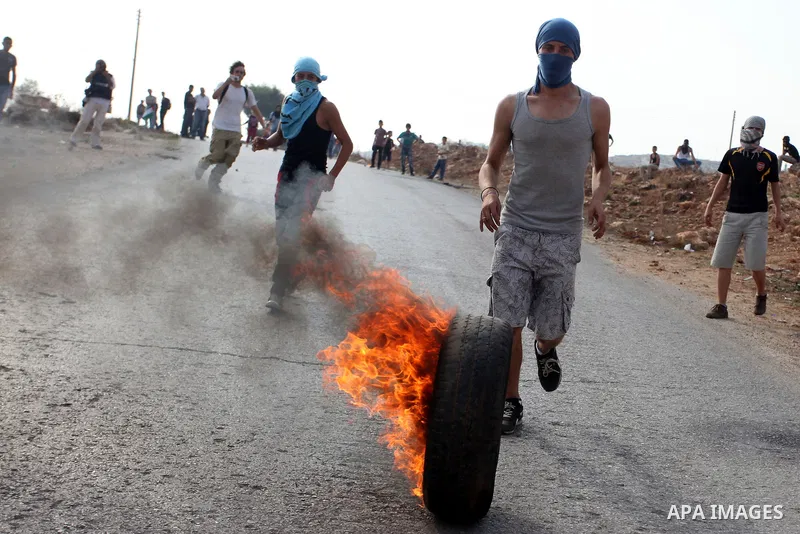 Palestinians argue with Israeli soldiers during a protest against the expansion of the nearby Jewish settlement of Halamish, in the West Bank village of Nabi Saleh near Ramallah, Friday, Nov. 2, 2012. Photo by Issam Rima...