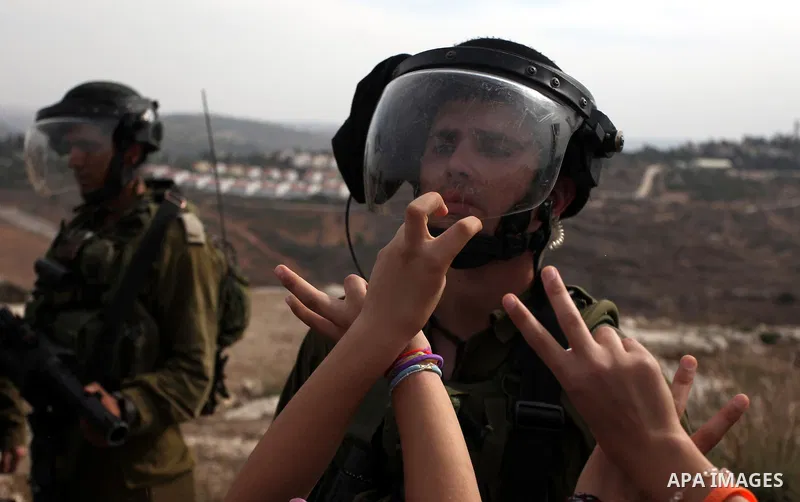 Palestinian girls scuffle with Israeli soldiers during a protest against the expansion of the nearby Jewish settlement of Halamish, in the West Bank village of Nabi Saleh near Ramallah, Friday, Nov 2, 2012. Photo by Issa...