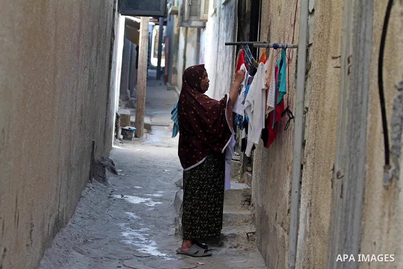 A Palestinian woman hangs laundry outside her house at the Shati Palestinian refugee camp in Gaza City on November 3, 2012. The issue of refugees is one of the thorniest elements of the Palestinian-Israeli conflict, with...