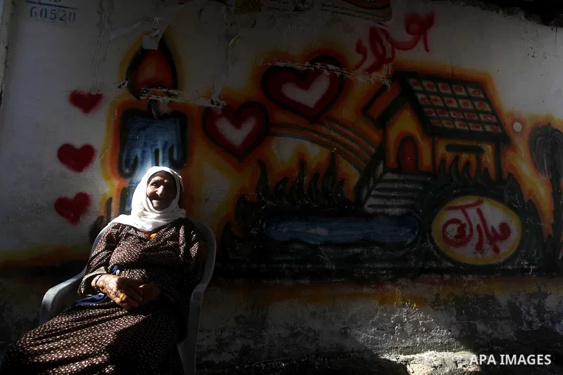 An elder Palestinian refugee woman sits next her house at the Shati Palestinian refugee camp in Gaza City on November 3, 2012. The issue of refugees is one of the thorniest elements of the Palestinian-Israeli conflict, w...