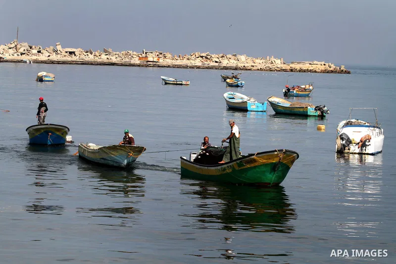 Palestinian fishermen enjoy their fishing time on the sea, during press conference about trial proceedings criminals Marmara massacre in Gaza port, on Nov. 04, 2012. Photo by Ashraf Amra