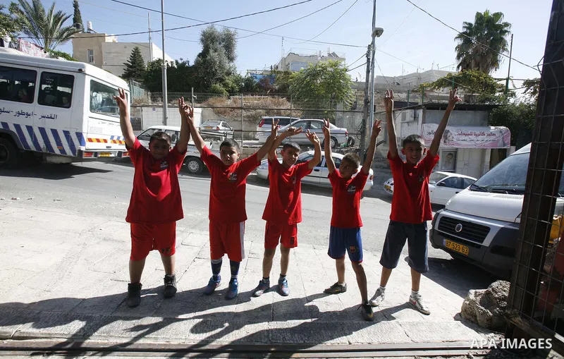 Palestinian children participate in the marathon of " Run for Silwan" in Jerusalem on 4 November 2012. The run for Silwan marathon highlights checkpoint system from Bethlehem to Wadi Hilweh, participants follow a route s...