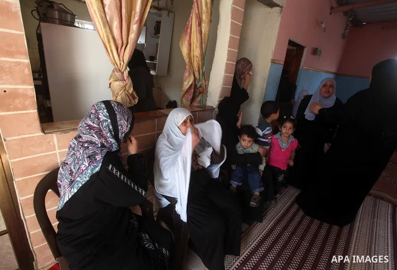 Relatives of Palestinian Ahmed al-Nabaheen mourn next to his body during his funeral at the Bureij refugee camp in the central Gaza Strip November 5, 2012. Israeli soldiers have shot and killed al-Nabaheen, a Palestinian...