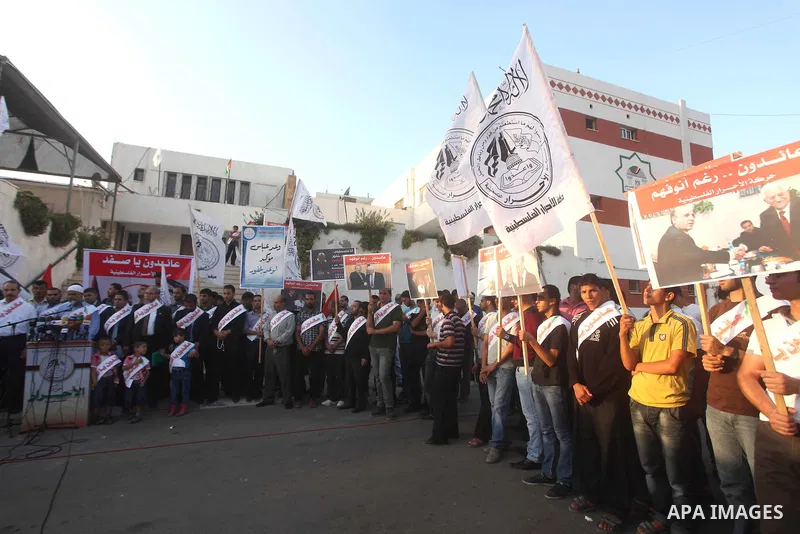 El-Ahrar party supporters carry placards and posters of Palestinian President Mahmoud Abbas with Israeli leaders during a demonstration in Gaza city on November 6, 2012. Protestors gathered to express their anger towards...
