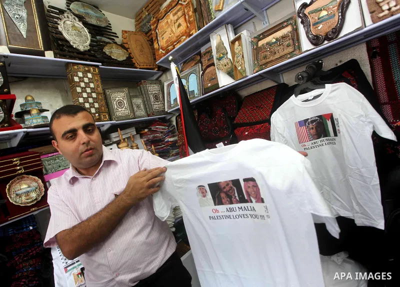 A Palestinian shop owner displays mugs for sale with portraits of leaders including US President Barack Obama, at a souvenir shop in Gaza City on Nov. 07, 2012. Democratic President Obama defeated Republican candidate Mi...