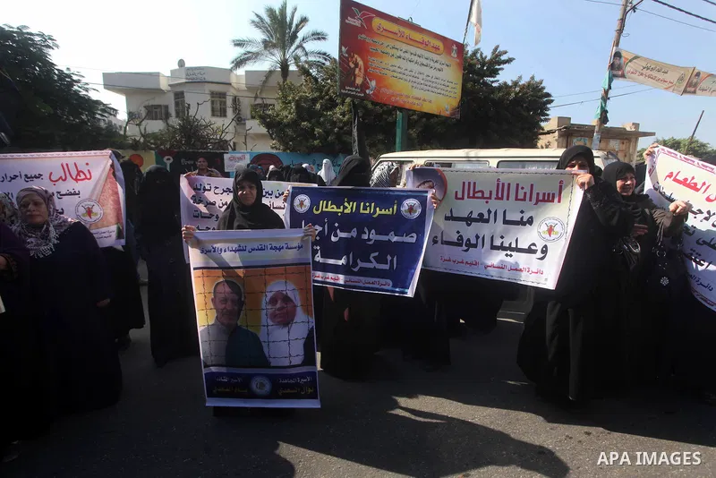 Palestinians woman participate a protest outside the International Red Cross building in Gaza City, to calling for the release from Palestinian prisoners Bassam al-Saadi, Nawal Saadi in Israeli jails and in support of pr...