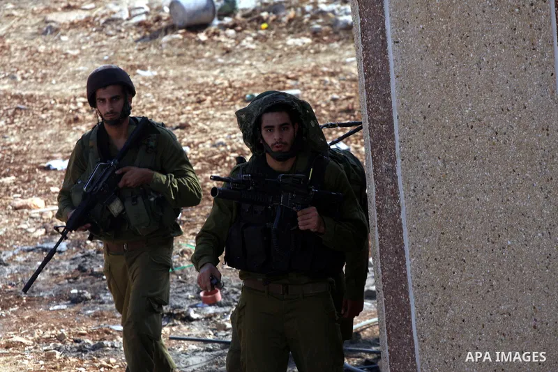 Israeli soldiers fire tear gas at Palestinians during demolition a Palestinian house by Israeli bulldozers in the village of Haris near Salfit southern the West Bank city Of Nablus on November 7, 2012. Demolition of Pale...