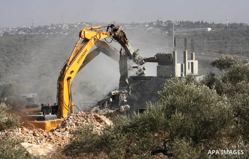 An Israeli bulldozer demolishes a Palestinian house in the village of Haris near Salfit southern the West Bank city Of Nablus on November 7, 2012. Demolition of Palestinian properties and Israeli settlement construction...