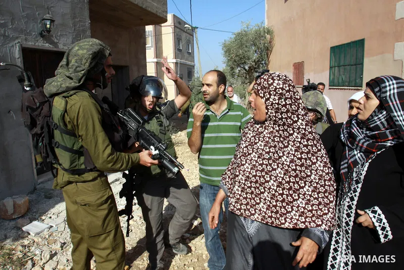 Palestinians scuffle with Israeli soldiers during demolition a Palestinian house by Israeli bulldozers in the village of Haris near Salfit southern the West Bank city Of Nablus on November 7, 2012. Demolition of Palestin...