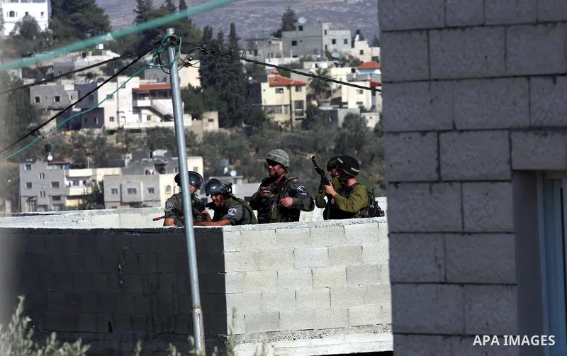 Israeli soldiers fire tear gas at Palestinians during demolition a Palestinian house by Israeli bulldozers in the village of Haris near Salfit southern the West Bank city Of Nablus on November 7, 2012. Demolition of Pale...