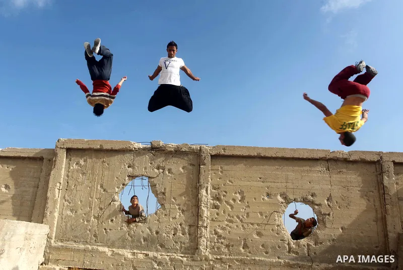 Palestinians youth practice his parkour skills, also known as free running, in the town of Khan Younis, in the southern Gaza Strip, on November 8, 2012. Some youths, aged between 12 and 23 years old, in Gaza are pracitis...