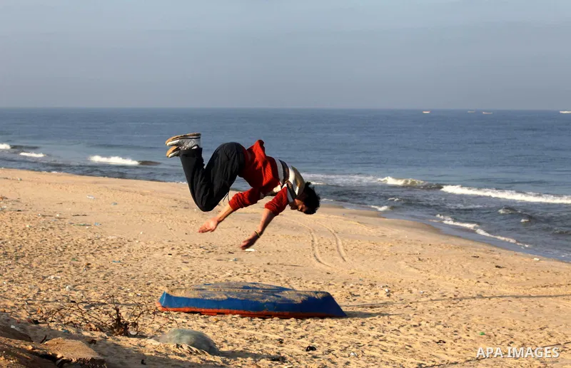 Palestinians youth practice his parkour skills, also known as free running, in the town of Khan Younis, in the southern Gaza Strip, on November 8, 2012. Some youths, aged between 12 and 23 years old, in Gaza are pracitis...
