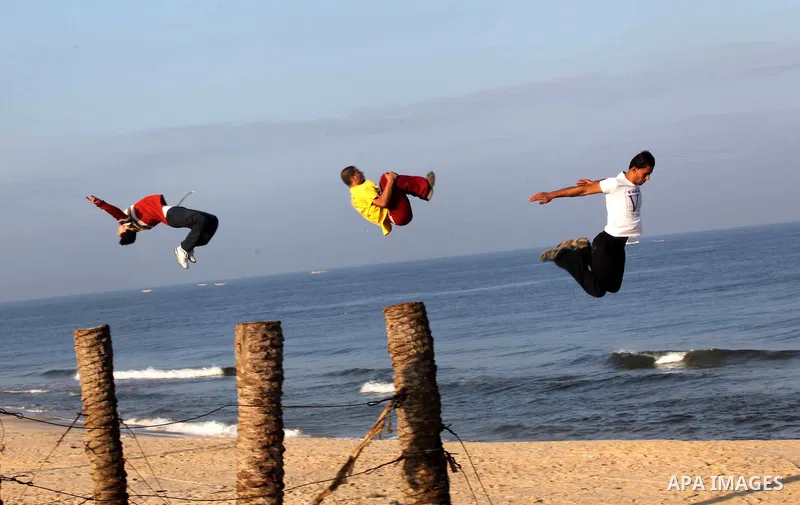 Palestinians youth practice his parkour skills, also known as free running, in the town of Khan Younis, in the southern Gaza Strip, on November 8, 2012. Some youths, aged between 12 and 23 years old, in Gaza are pracitis...