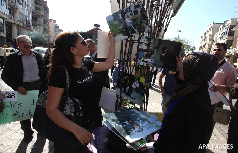 Palestinian journalists hold placards during a protest against the violations of their rights by Israeli authorities on the international day to end impunity, in the West Bank city of Ramallah on November 08, 2012. In th...