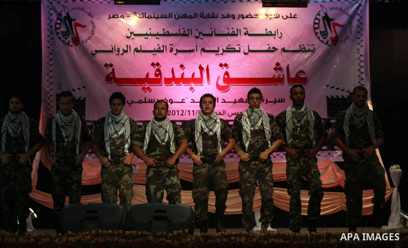 Palestinians perform dance during the ceremony of the first show of the Palestinian-Egyptian Film "Lover of Rifle" in Gaza on November 8, 2012. Lover of Rifle is the first joint movie between Palestinian and Egyptian art...