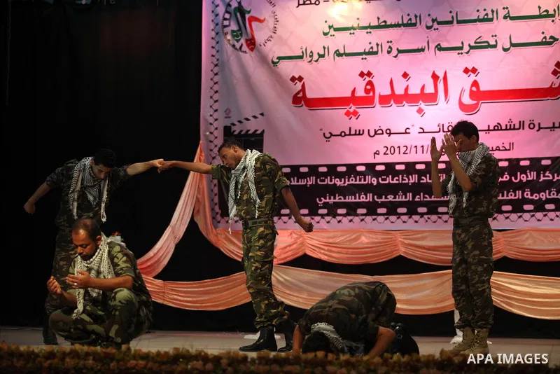 Palestinians perform dance during the ceremony of the first show of the Palestinian-Egyptian Film "Lover of Rifle" in Gaza on November 8, 2012. Lover of Rifle is the first joint movie between Palestinian and Egyptian art...