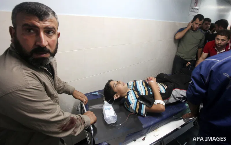 A wounded Palestinian is wheeled on a stretcher at a hospital in Gaza City following Israeli shelling November 10, 2012. Israeli tank shells killed at least two Palestinians and wounded 20 in the Gaza Strip on Saturday a...