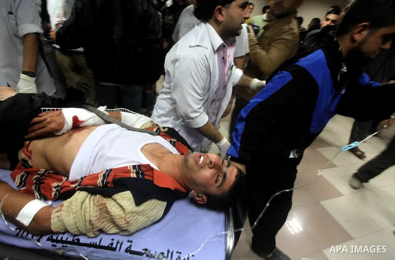 A wounded Palestinian is wheeled on a stretcher at a hospital in Gaza City following Israeli shelling November 10, 2012. Israeli tank shells killed at least two Palestinians and wounded 20 in the Gaza Strip on Saturday a...