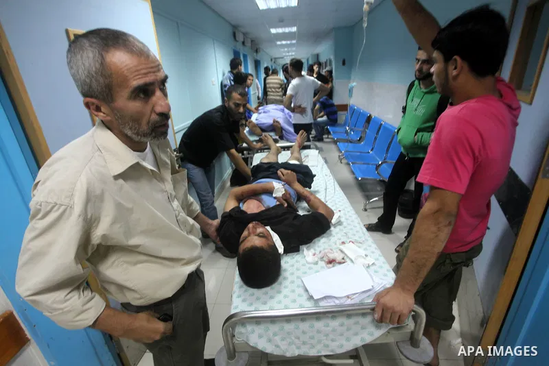 A wounded Palestinian is wheeled on a stretcher at a hospital in Gaza City following Israeli shelling November 10, 2012. Israeli tank shells killed at least two Palestinians and wounded 20 in the Gaza Strip on Saturday a...