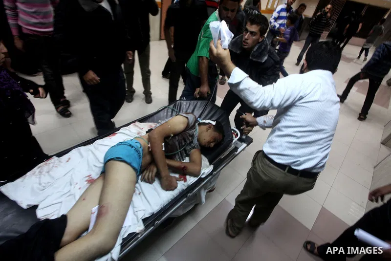 A wounded Palestinian is wheeled on a stretcher at a hospital in Gaza City following Israeli shelling November 10, 2012. Israeli tank shells killed at least two Palestinians and wounded 20 in the Gaza Strip on Saturday a...