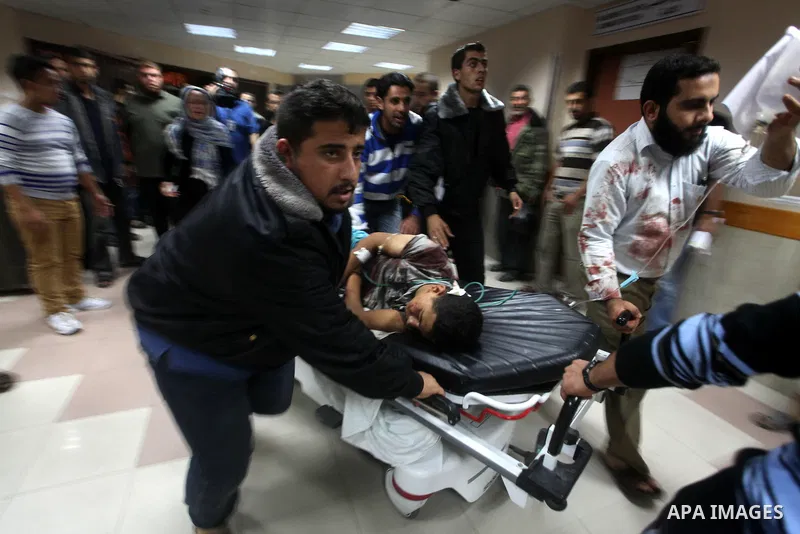 A wounded Palestinian is wheeled on a stretcher at a hospital in Gaza City following Israeli shelling November 10, 2012. Israeli tank shells killed at least two Palestinians and wounded 20 in the Gaza Strip on Saturday a...
