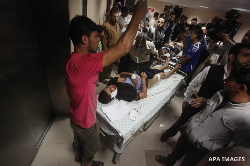 A wounded Palestinian is wheeled on a stretcher at a hospital in Gaza City following Israeli shelling November 10, 2012. Israeli tank shells killed at least two Palestinians and wounded 20 in the Gaza Strip on Saturday a...